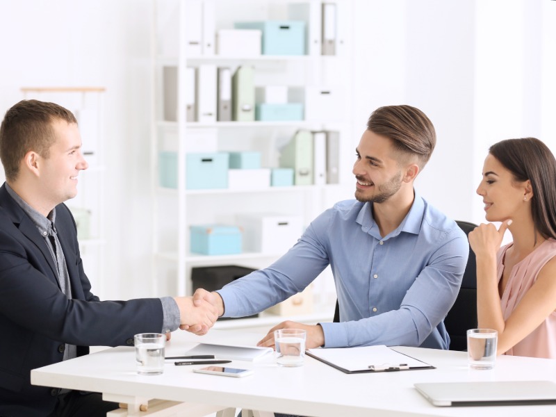 Clients shaking hands with accountant